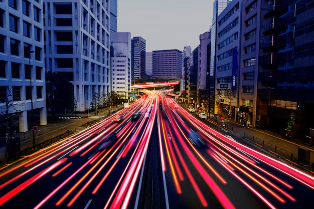 City at dusk with motion light trails, representing momentum for US businesses building with Noseberry